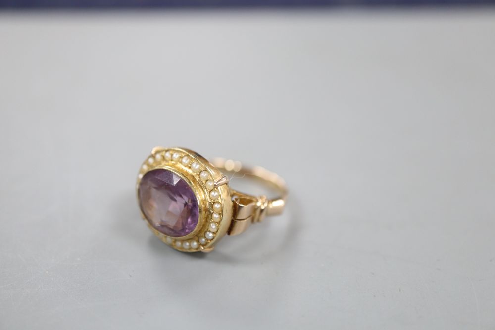 A 19th century style 14k, oval cut amethyst and seed pearl set dress ring, size O, gross 6.1 grams.